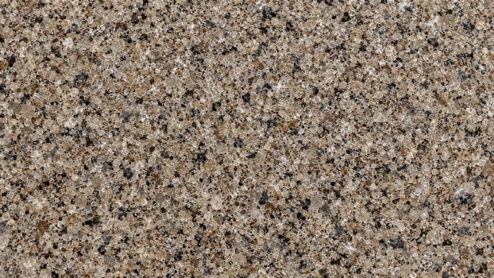 Top-down close-up of a tan, brown, gray and black quartz blend garage floor